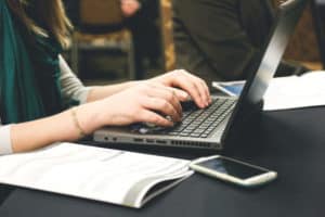 Woman writing at a laptop